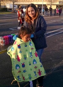 A woman gives a haircut to a child outdoors, channeling the expertise of *Salon Today 200*. The child is seated with a colorful cape depicting cartoon monsters.