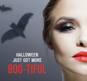 Close-up of a woman's face with dramatic makeup against a dark background featuring flying bats and text reading "Halloween Just Got More Boo-tiful.