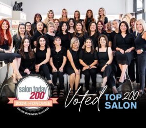 Group photo of salon staff with a "Salon Today 200 2024 Honoree, Voted Top 200 Salon" badge displayed in the foreground.